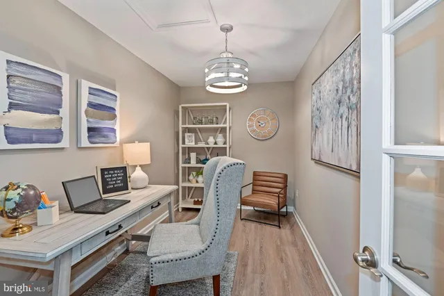 a view of a hallway with workspace and dining area