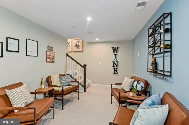a living room with furniture and painting on the wall