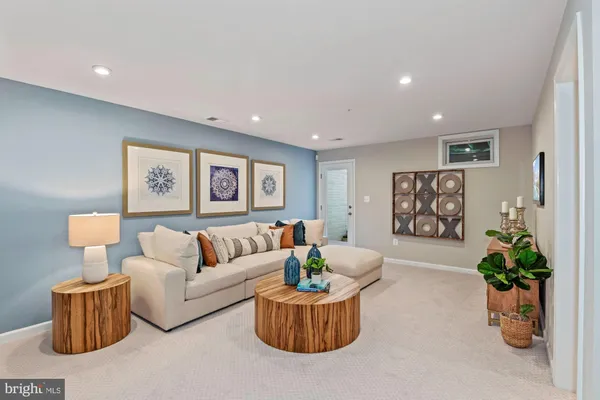 a living room with furniture and a potted plant