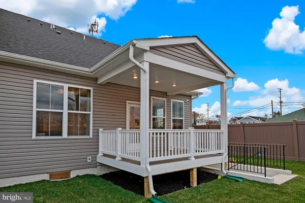 a view of a house with a yard and deck