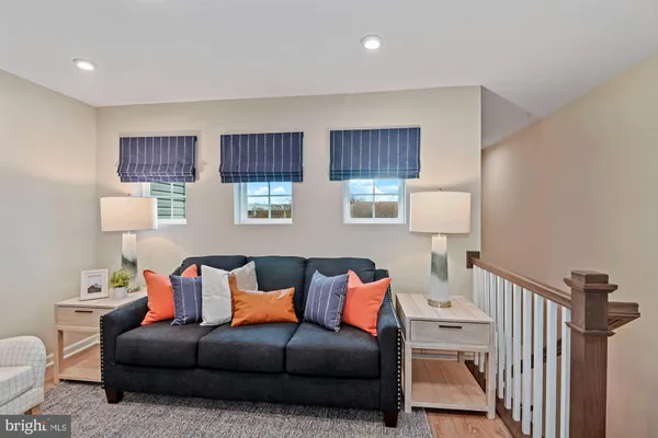 a living room with furniture a lamp and a window