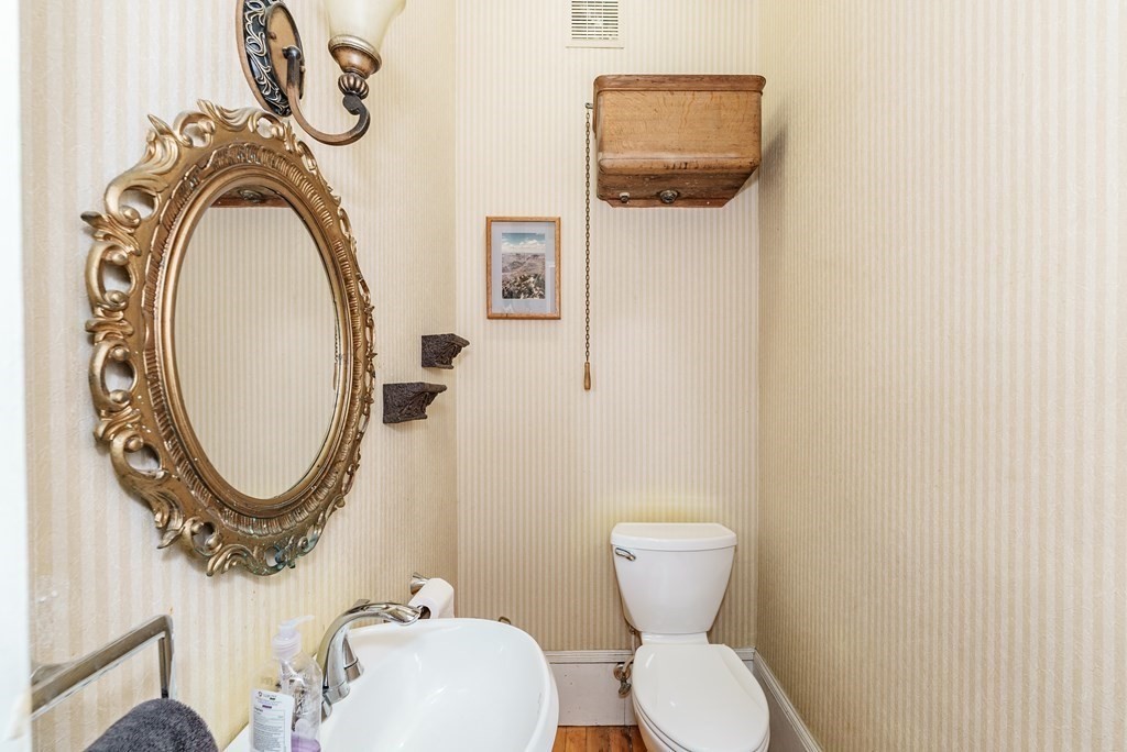 19 Mattoon Street Springfield, MA 01105 - Photo 13 of 42 a bathroom with a toilet mirror and vanity