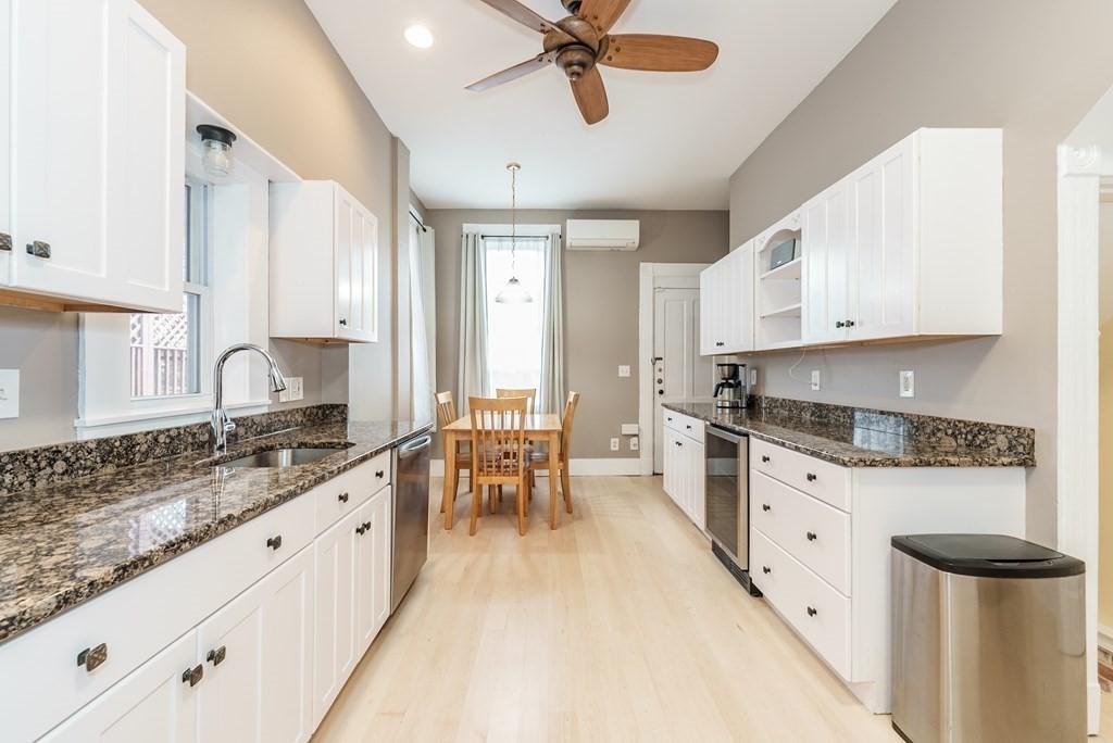 19 Mattoon Street Springfield, MA 01105 - Photo 15 of 42 a kitchen with granite countertop cabinets a sink a window and stainless steel appliances