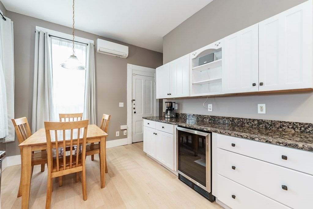 19 Mattoon Street Springfield, MA 01105 - Photo 16 of 42 a kitchen with granite countertop white cabinets and white appliances