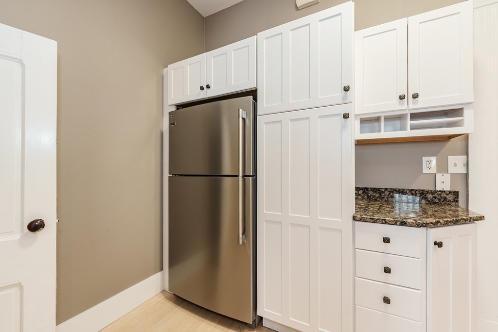 19 Mattoon Street Springfield, MA 01105 - Photo 17 of 42 a kitchen with white cabinets and white appliances
