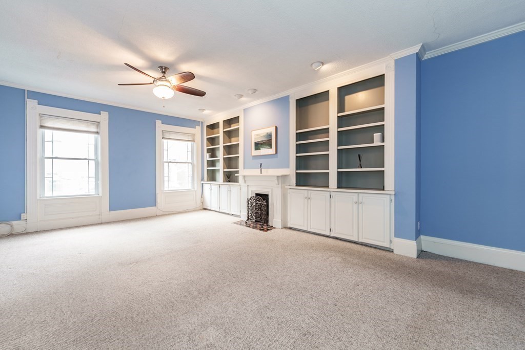 19 Mattoon Street Springfield, MA 01105 - Photo 21 of 42 a view of an empty room with a window and fireplace