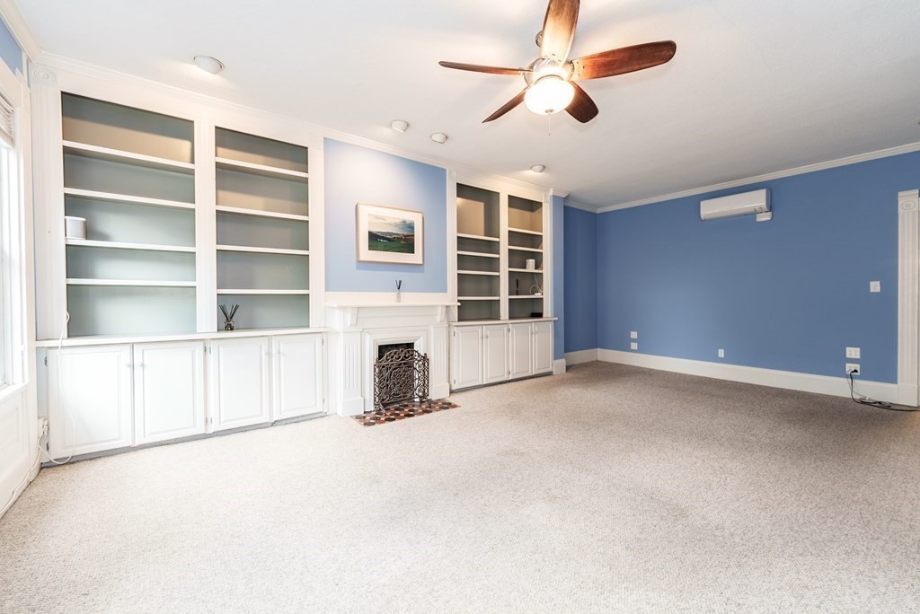 19 Mattoon Street Springfield, MA 01105 - Photo 24 of 42 a view of an empty room with a fireplace and a window