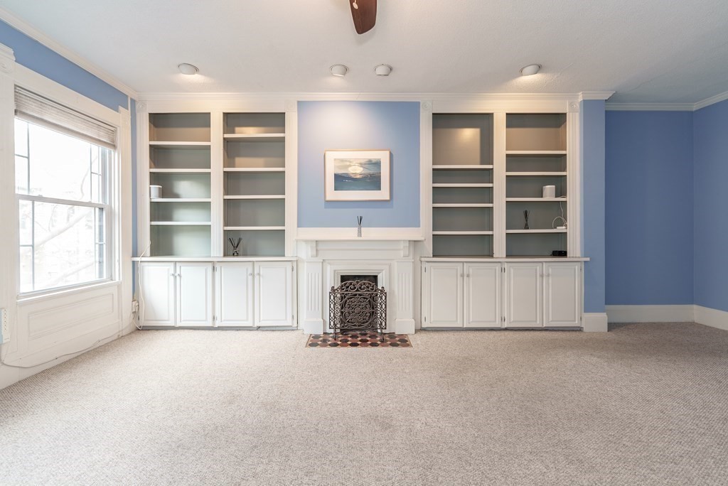 19 Mattoon Street Springfield, MA 01105 - Photo 25 of 42 a view of an empty room with a fireplace and window