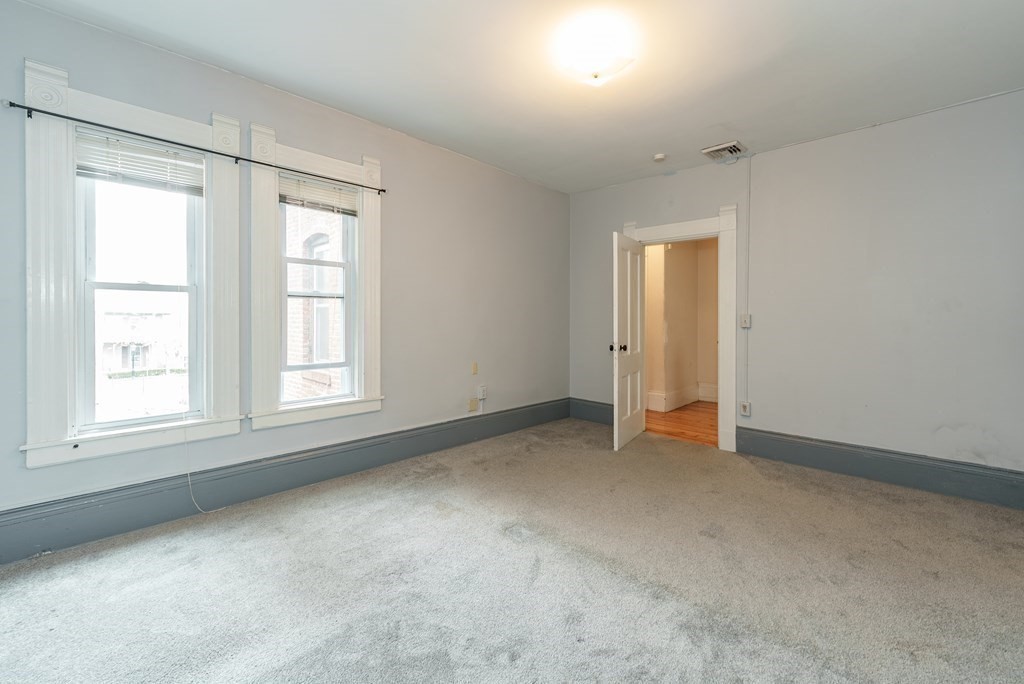 19 Mattoon Street Springfield, MA 01105 - Photo 32 of 42 an empty room with windows and closet