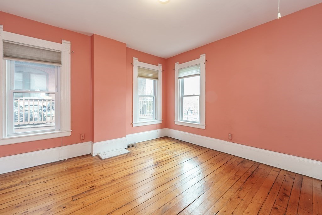 19 Mattoon Street Springfield, MA 01105 - Photo 34 of 42 a view of an empty room with wooden floor and a window