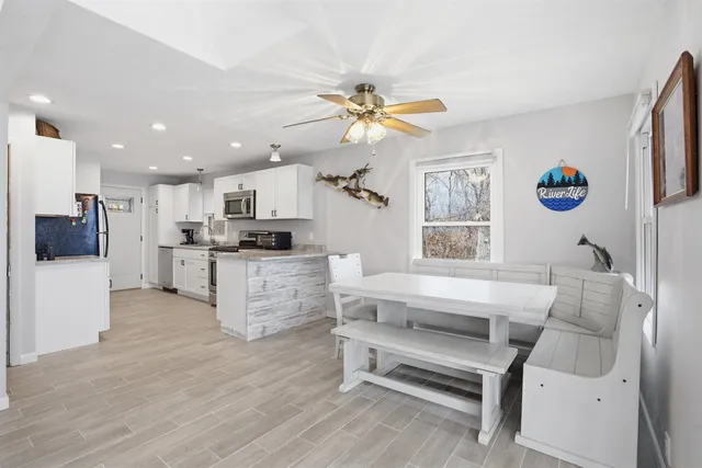 a living room with furniture and kitchen view