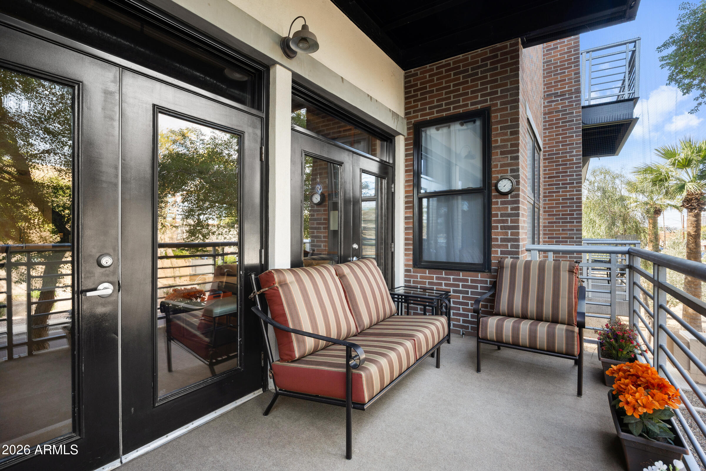 914 East Osborn Road, Unit 216 Phoenix, AZ 85014 - Photo 14 of 26 a balcony with furniture and a potted plant
