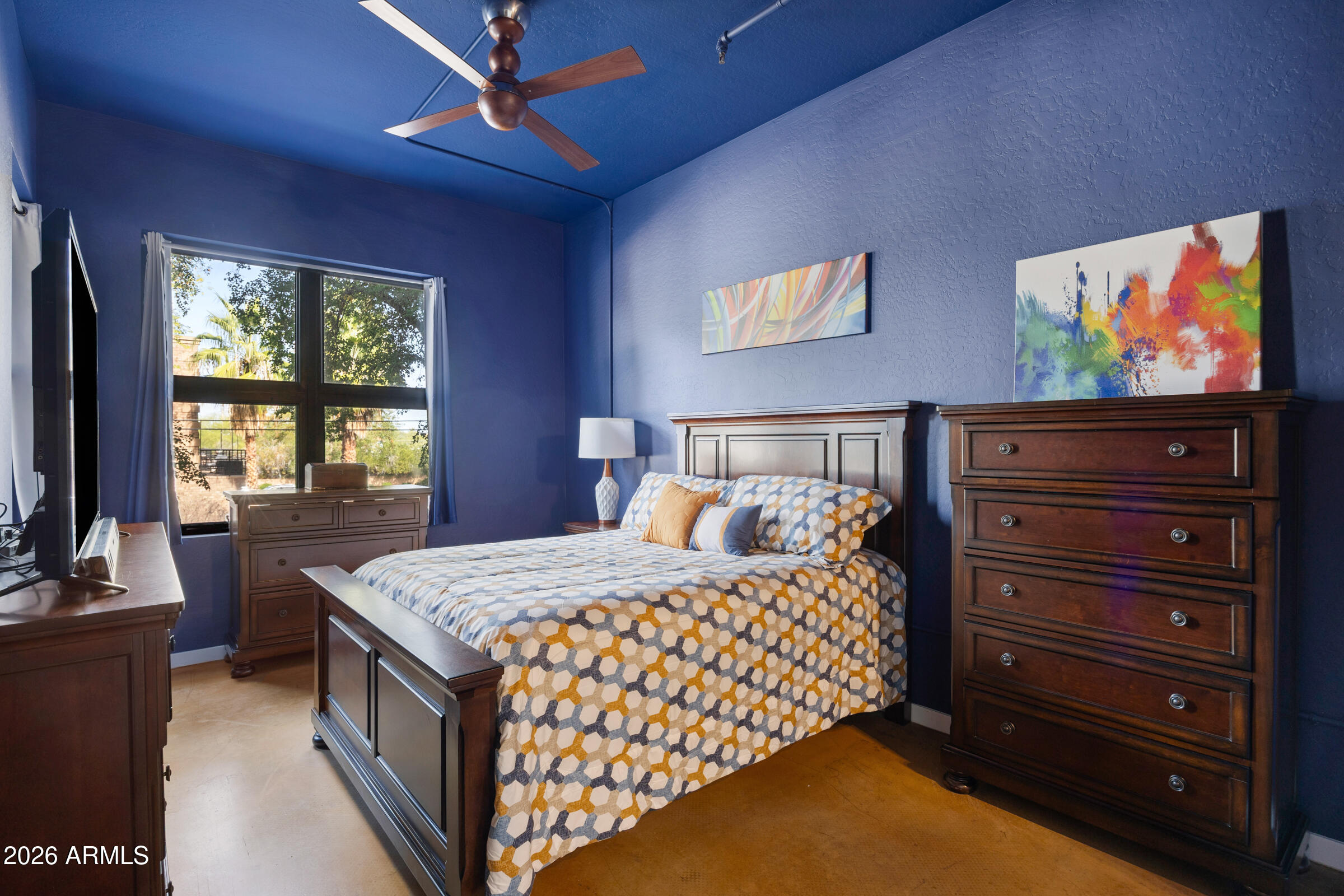 914 East Osborn Road, Unit 216 Phoenix, AZ 85014 - Photo 15 of 26 a bedroom with a bed and a flat screen tv