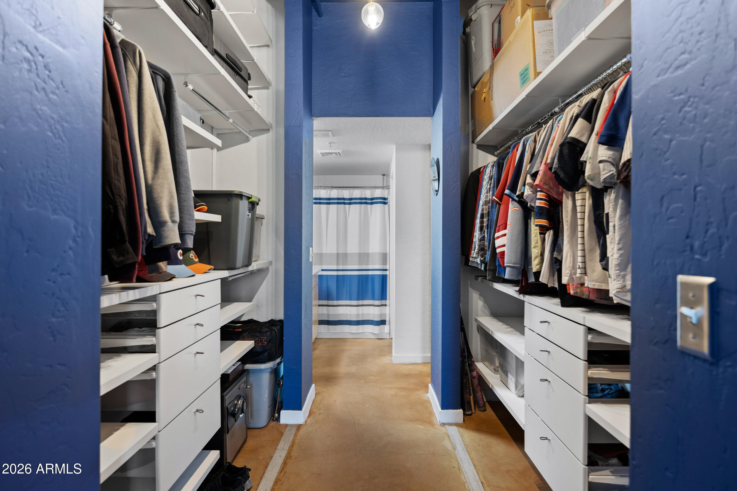 914 East Osborn Road, Unit 216 Phoenix, AZ 85014 - Photo 17 of 26 a view of walk in closet with clothes and shoes