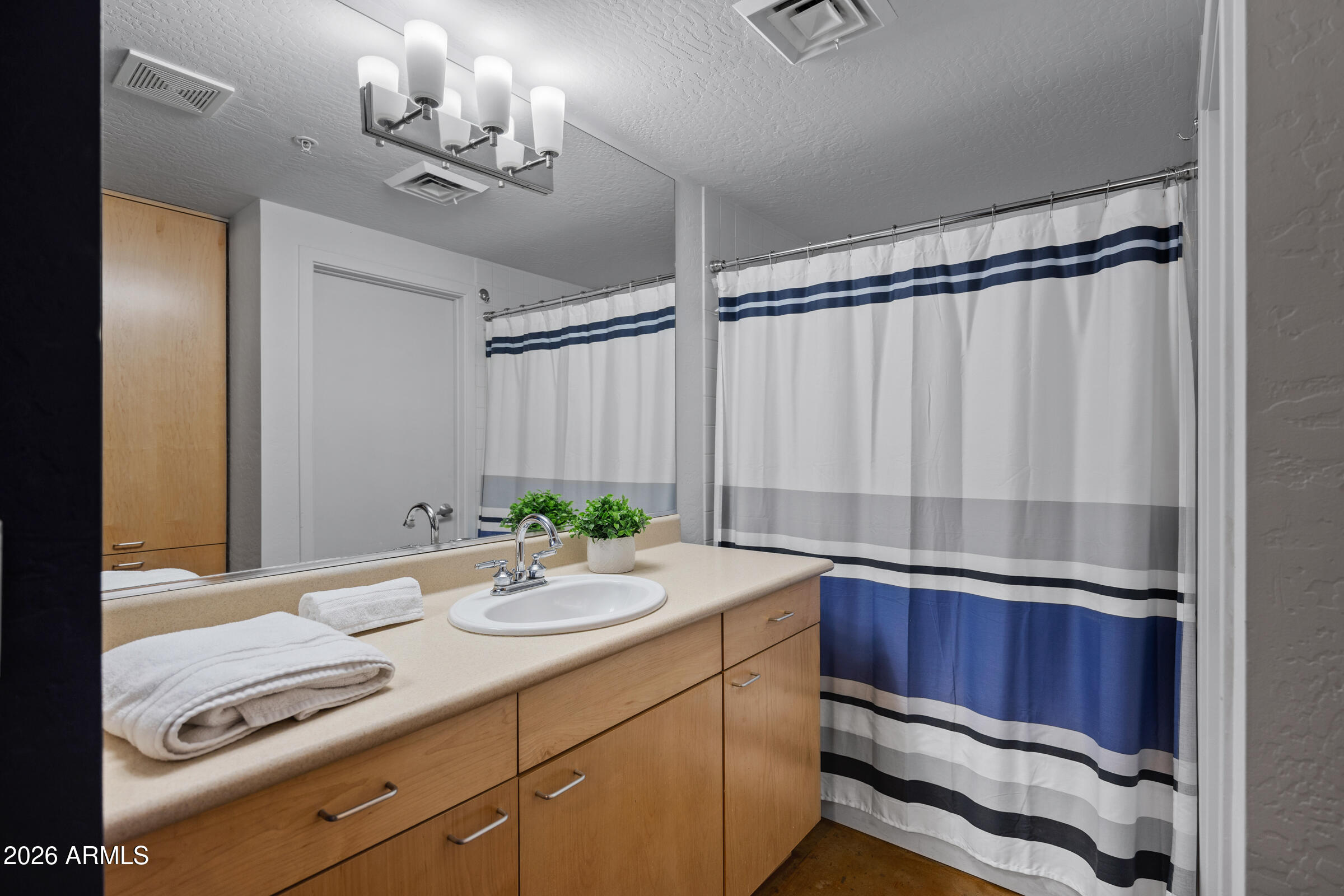 914 East Osborn Road, Unit 216 Phoenix, AZ 85014 - Photo 18 of 26 a bathroom with a sink a double vanity and a mirror