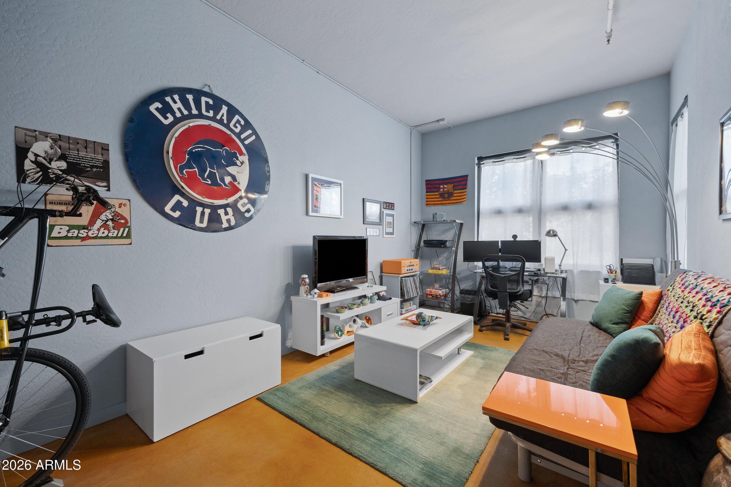 914 East Osborn Road, Unit 216 Phoenix, AZ 85014 - Photo 19 of 26 a living room with furniture a rug and a flat screen tv