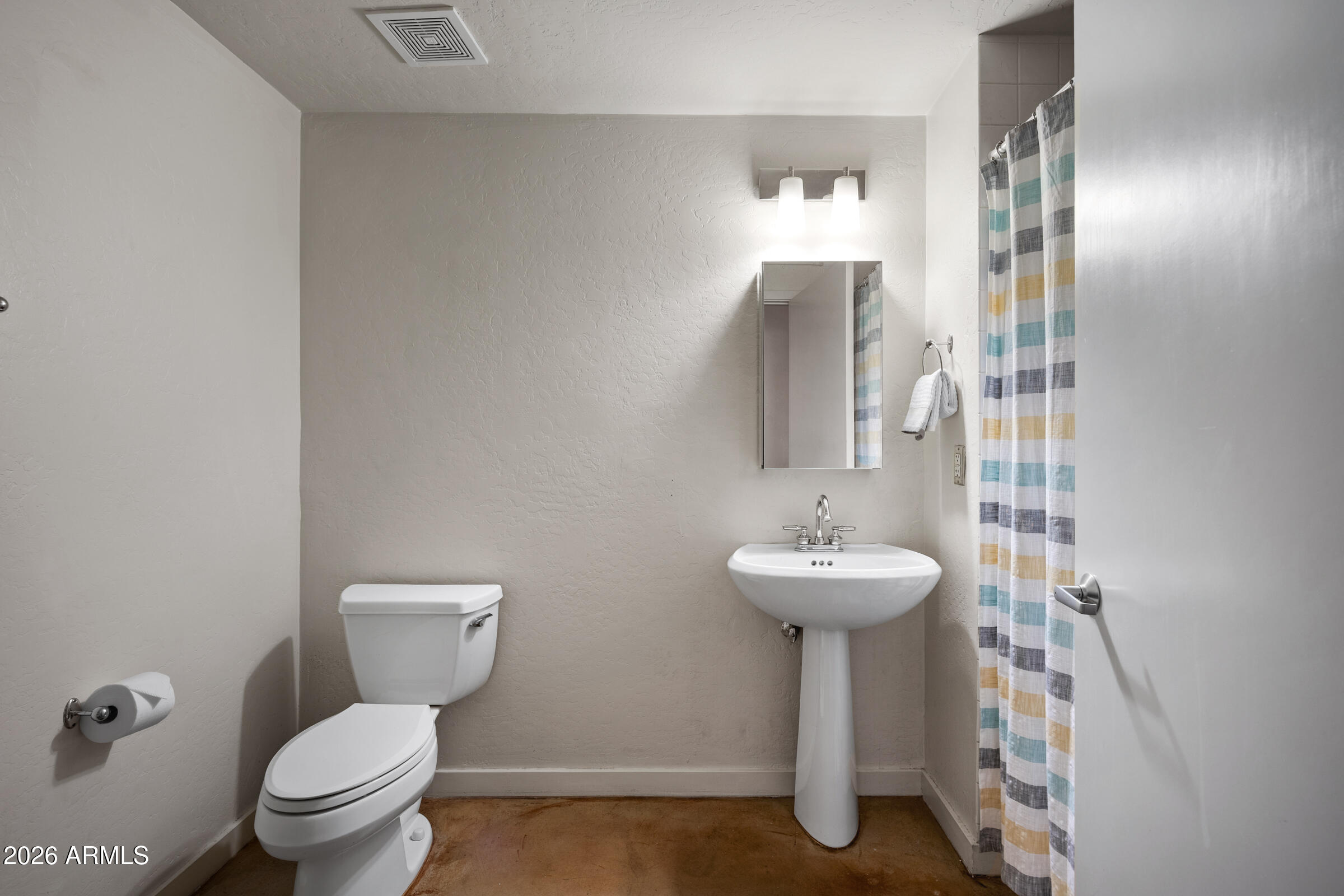 914 East Osborn Road, Unit 216 Phoenix, AZ 85014 - Photo 22 of 26 a bathroom with a sink toilet and a mirror