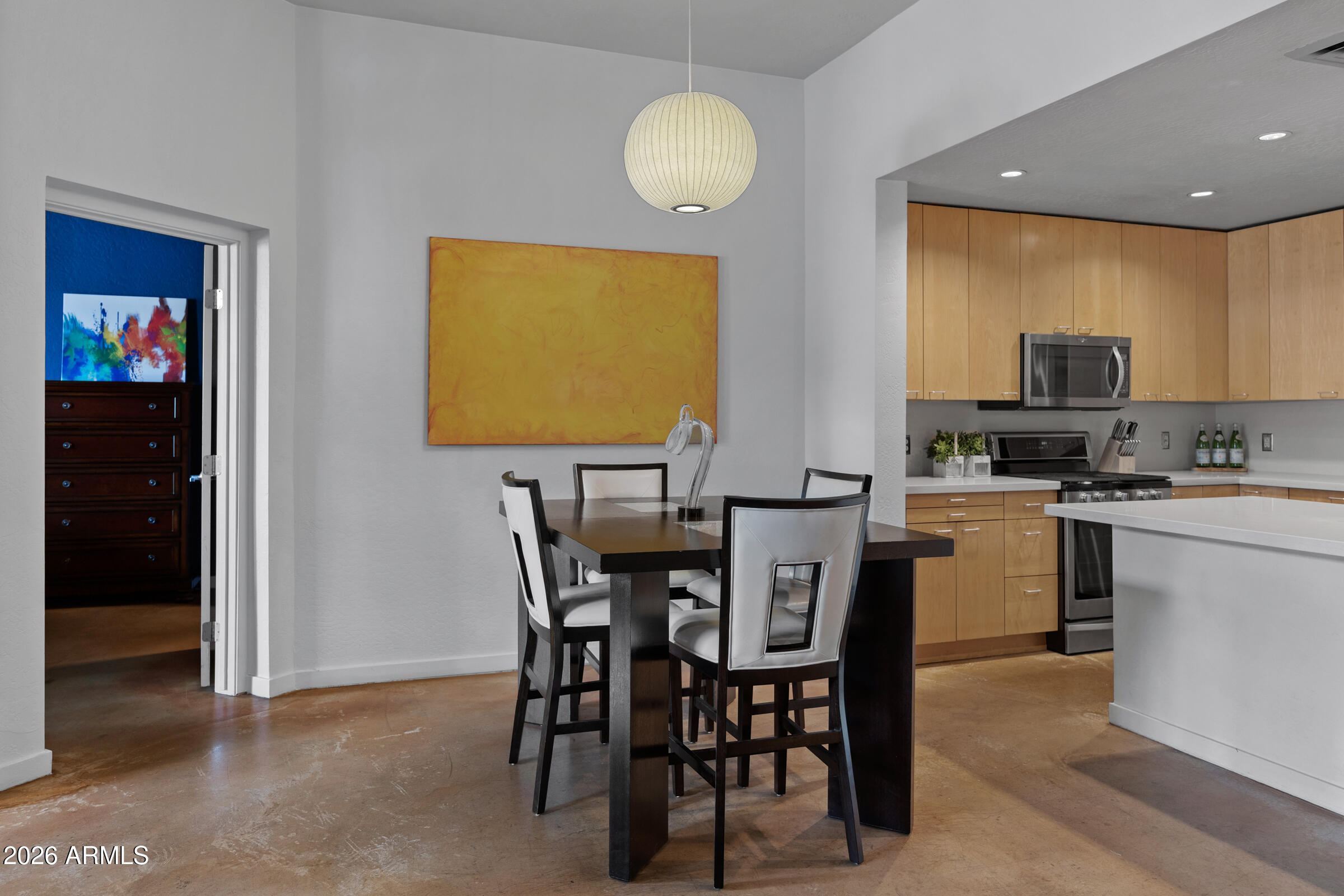 914 East Osborn Road, Unit 216 Phoenix, AZ 85014 - Photo 8 of 26 a kitchen with a table and chairs in it