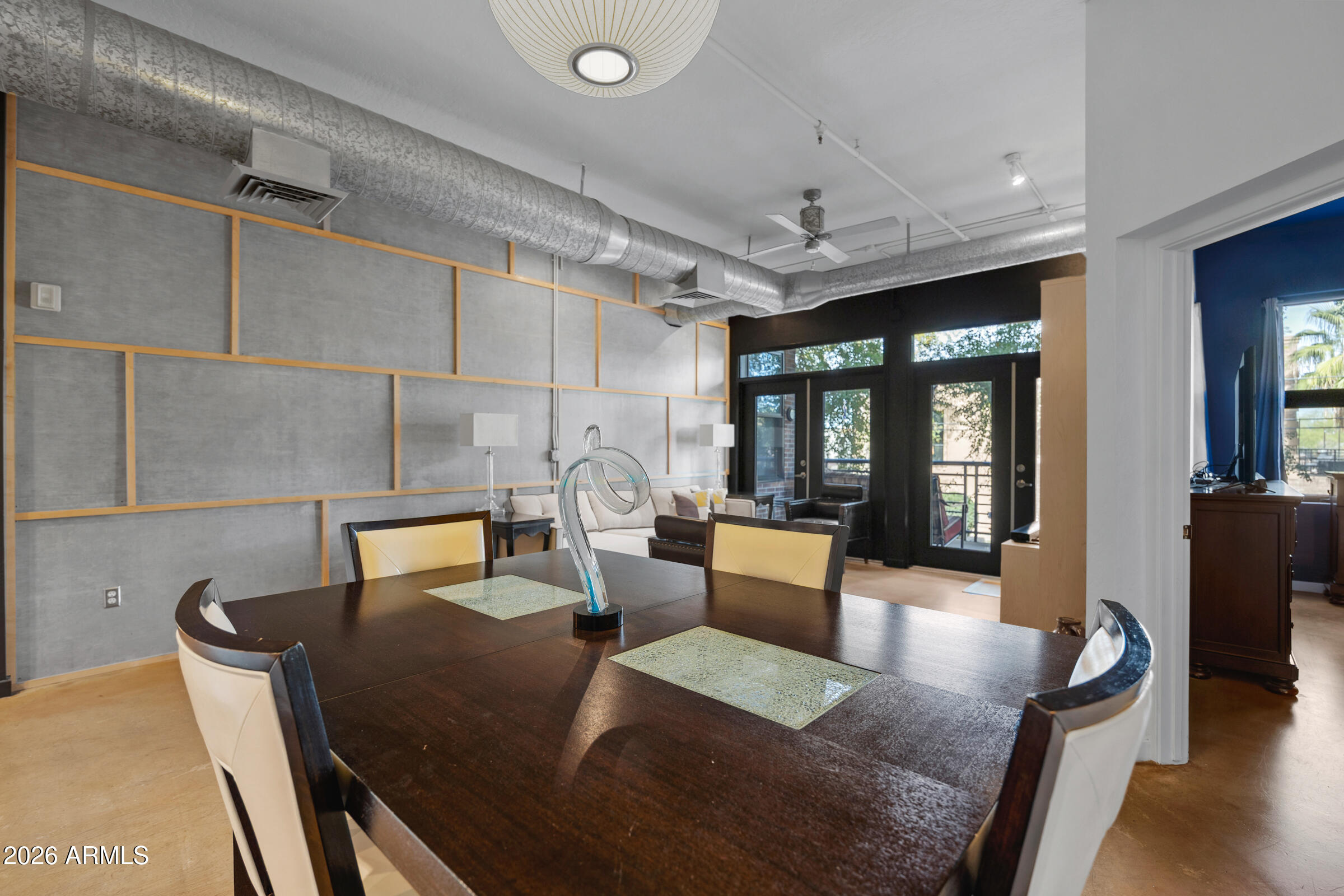 914 East Osborn Road, Unit 216 Phoenix, AZ 85014 - Photo 9 of 26 a view of a dining room with furniture a chandelier and wooden floor