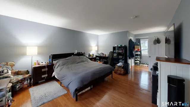 a bed room with a bed furniture and a flat tv screen