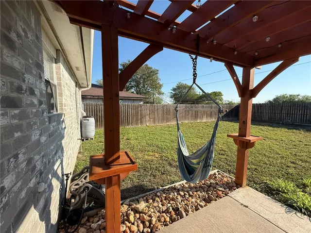 a front view of a house with garden view and a potted plant