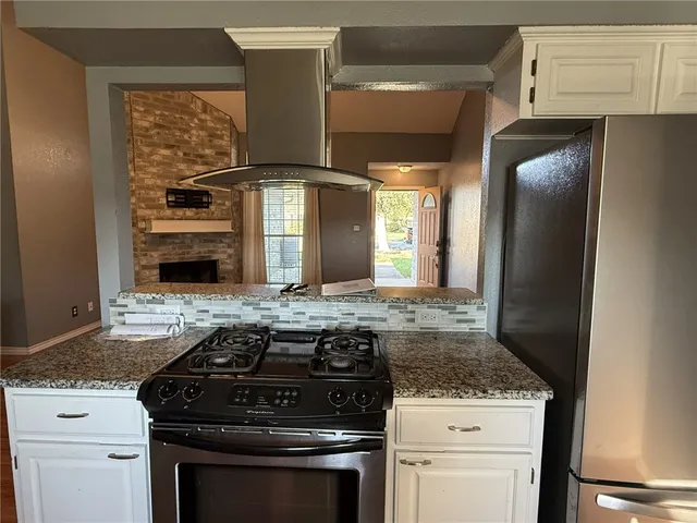 a stove top oven sitting inside of a kitchen