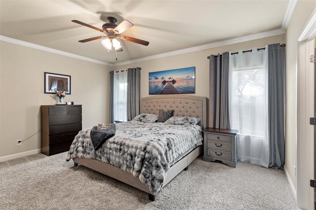 223 Cottongame Road Weatherford, TX 76088 - Photo 17 of 39 a bedroom with a bed and a chandelier