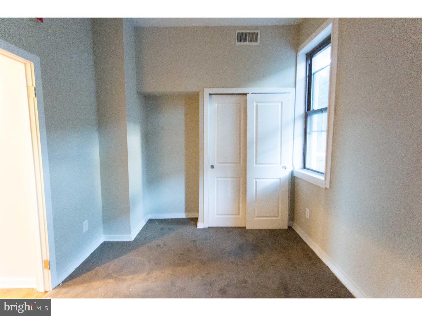 413 South 11th Street, Unit 3F Philadelphia, PA 19147 - Photo 13 of 15 a view of an empty room with wooden floor and a window