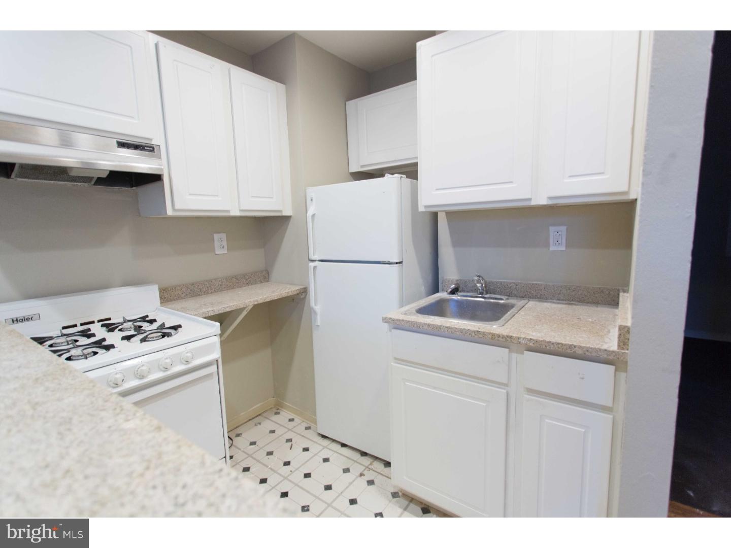 413 South 11th Street, Unit 3F Philadelphia, PA 19147 - Photo 7 of 15 a kitchen with a white cabinets stove and white kitchen