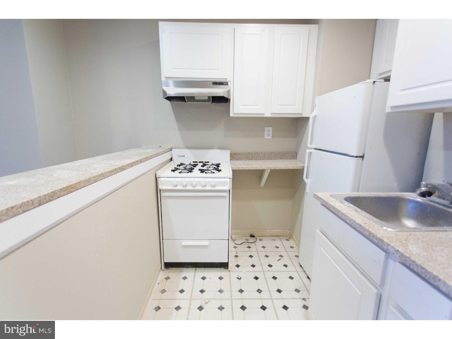 413 South 11th Street, Unit 3F Philadelphia, PA 19147 - Photo 8 of 15 a kitchen with a sink a stove and cabinets