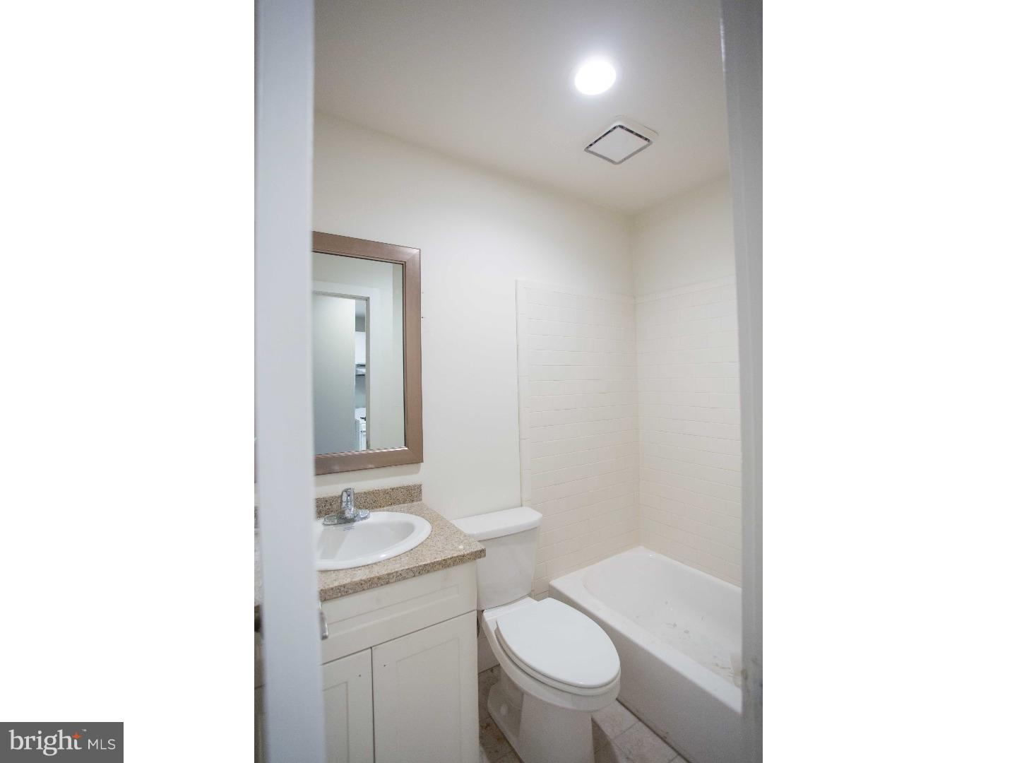413 South 11th Street, Unit 3F Philadelphia, PA 19147 - Photo 9 of 15 a bathroom with a toilet a sink and mirror