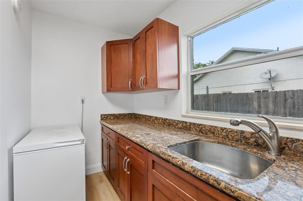 1525 Kestrel Way Brandon, FL 33511 - Photo 32 of 48 a kitchen with a sink and a refrigerator