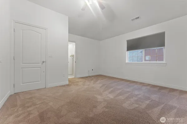 an empty room with windows and closet