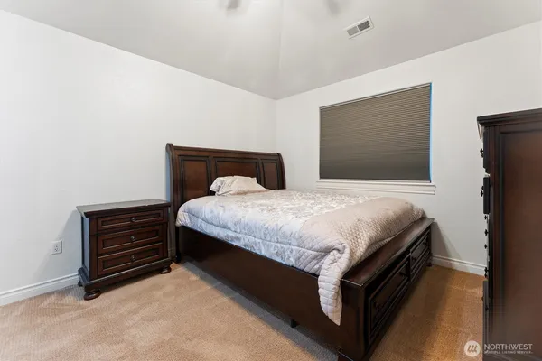 a bedroom with a bed and dresser