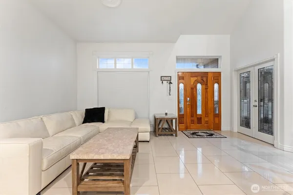 a living room with furniture a window and a potted plant