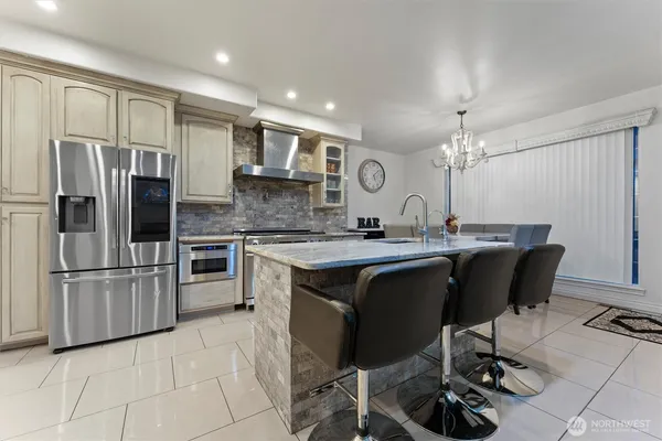 a kitchen with stainless steel appliances kitchen island granite countertop a sink and cabinets
