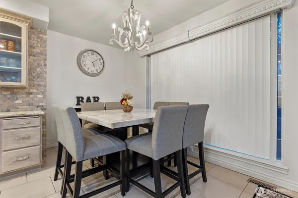 a view of a dining room with furniture and a chandelier