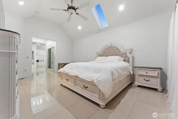 a bedroom with a bed and a chandelier