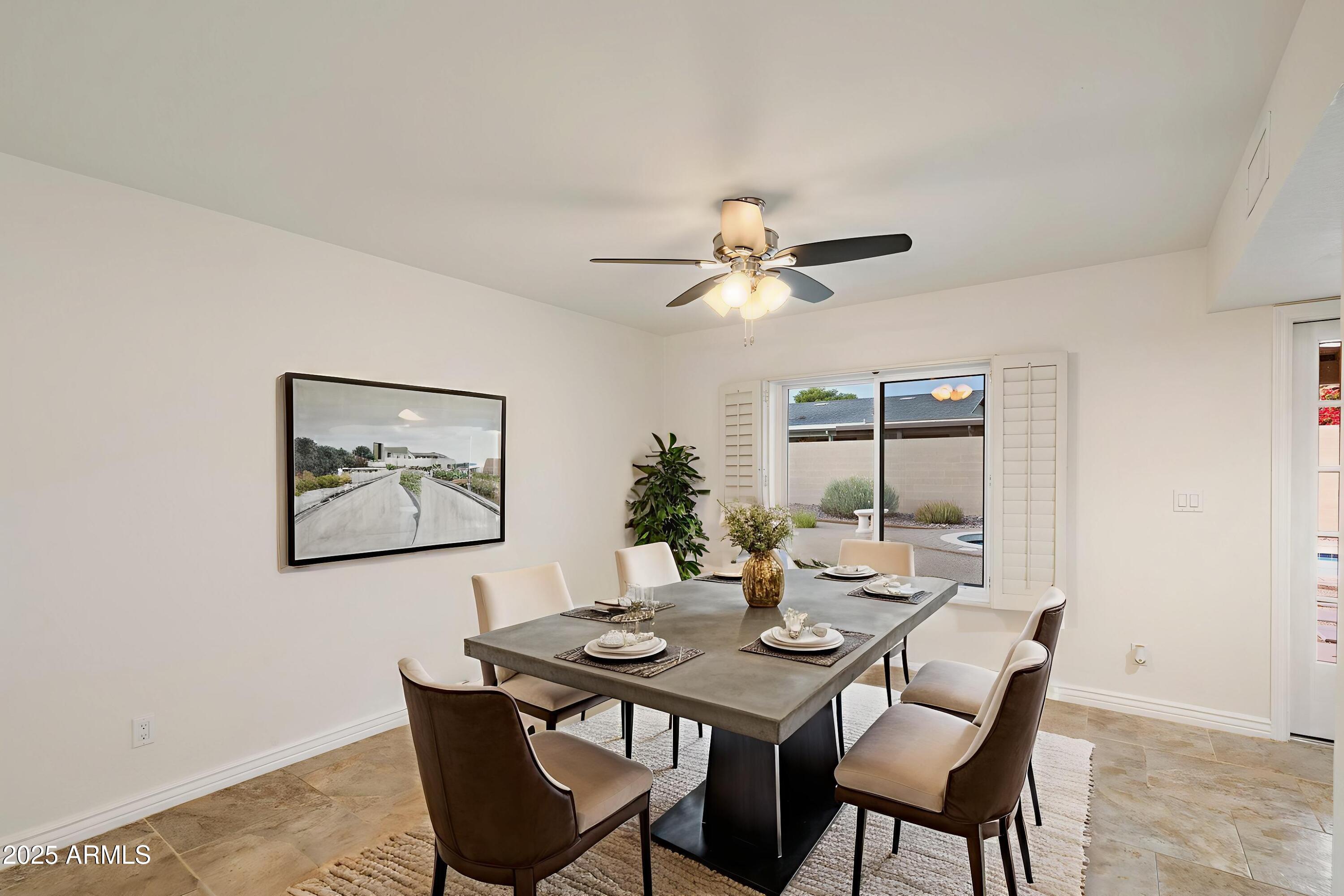 6242 East Hearn Road Scottsdale, AZ 85254 - Photo 12 of 40 a view of a dining room with furniture window and wooden floor