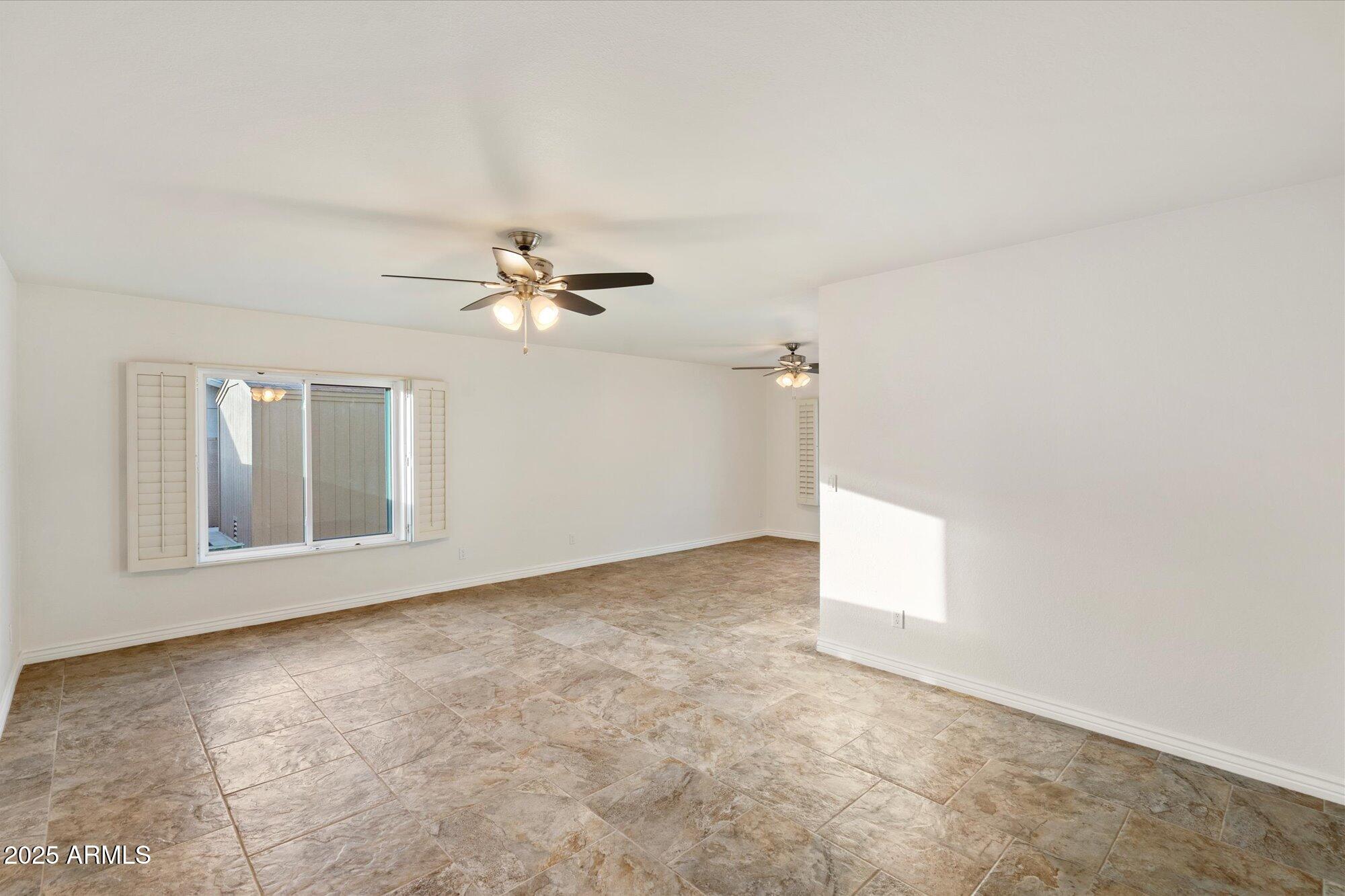 6242 East Hearn Road Scottsdale, AZ 85254 - Photo 13 of 40 a view of a livingroom with a ceiling fan and window