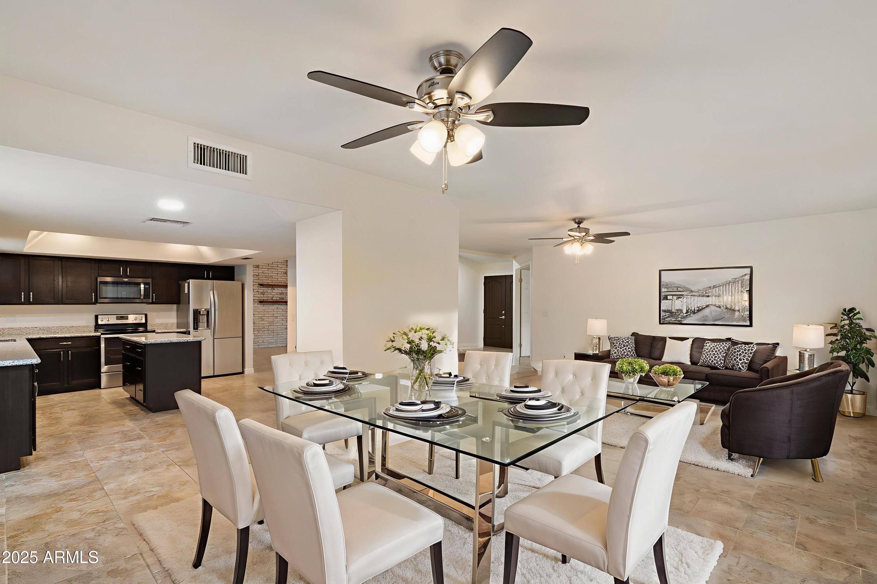 6242 East Hearn Road Scottsdale, AZ 85254 - Photo 16 of 40 a view of a dining room with furniture and a chandelier