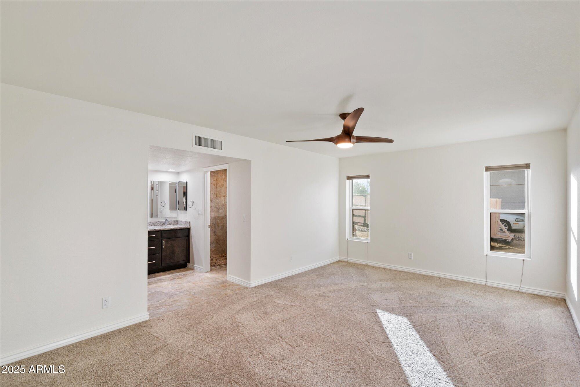 6242 East Hearn Road Scottsdale, AZ 85254 - Photo 17 of 40 a view of an empty room with window and cabinet