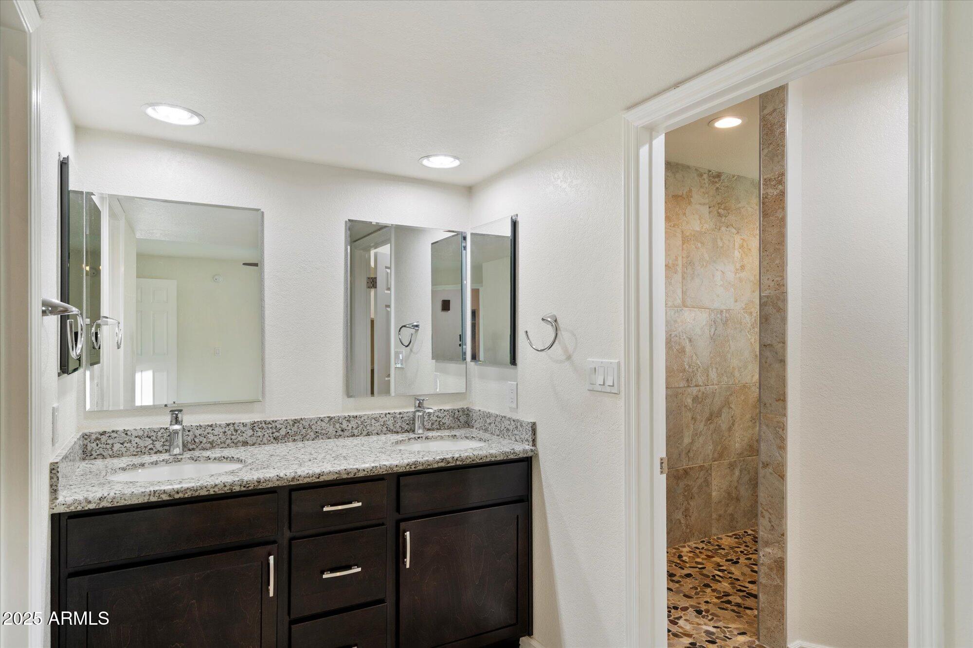 6242 East Hearn Road Scottsdale, AZ 85254 - Photo 19 of 40 a bathroom with a granite countertop sink and a mirror