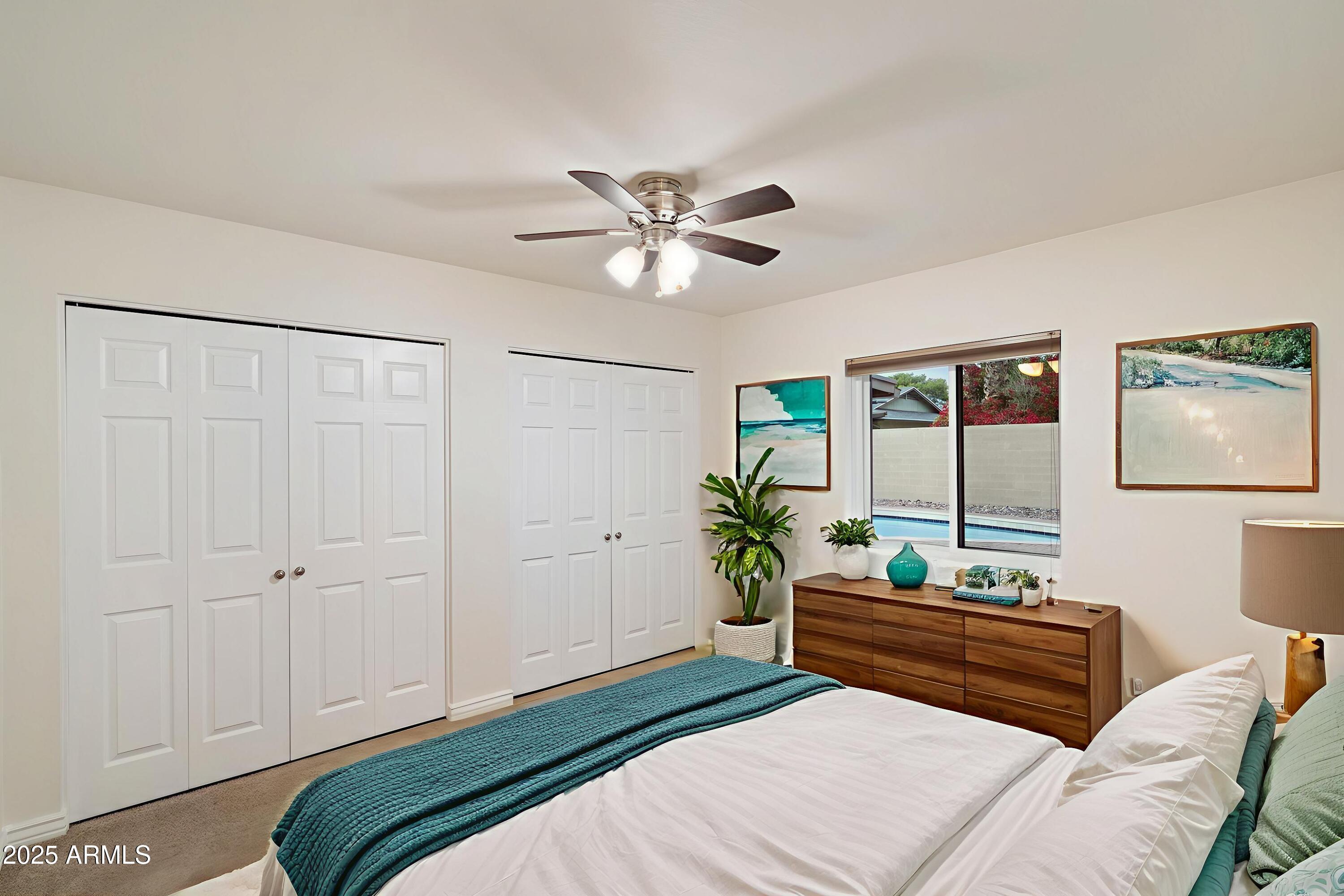 6242 East Hearn Road Scottsdale, AZ 85254 - Photo 27 of 40 a bedroom with a bed and a chandelier fan
