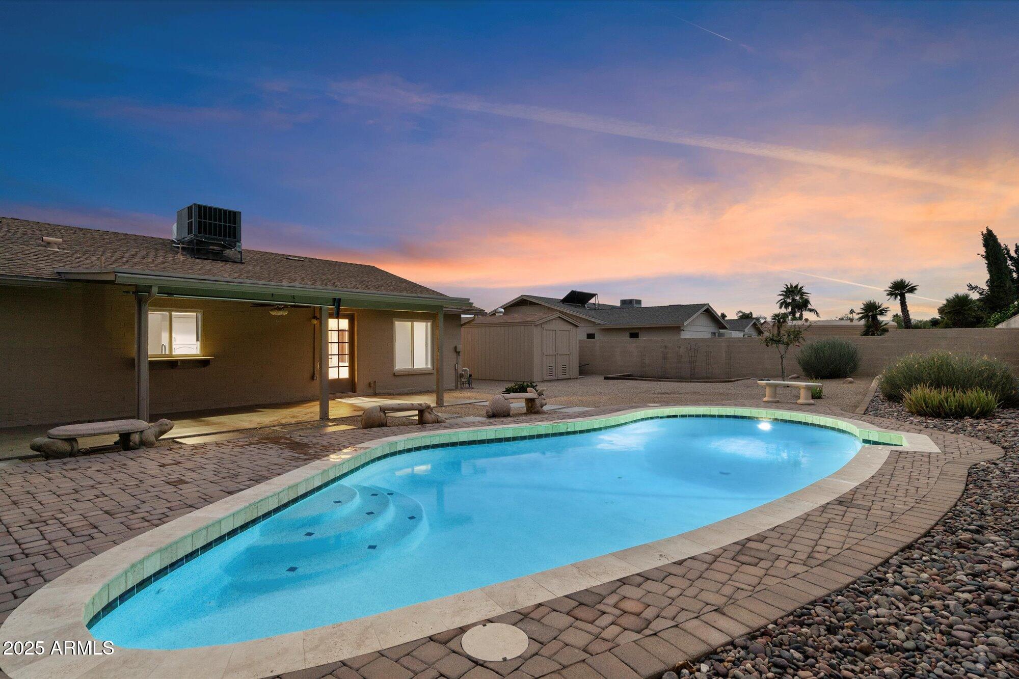 6242 East Hearn Road Scottsdale, AZ 85254 - Photo 32 of 40 a view of a swimming pool with a table and chairs