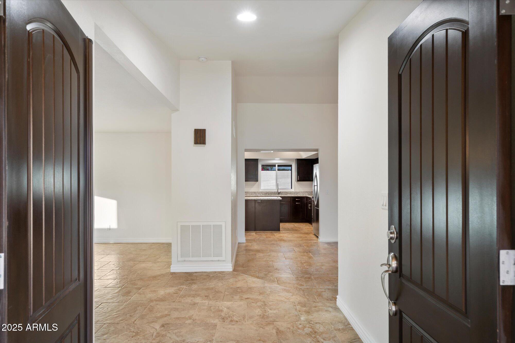 6242 East Hearn Road Scottsdale, AZ 85254 - Photo 5 of 40 a view of a hallway with wooden floor windows and a living room