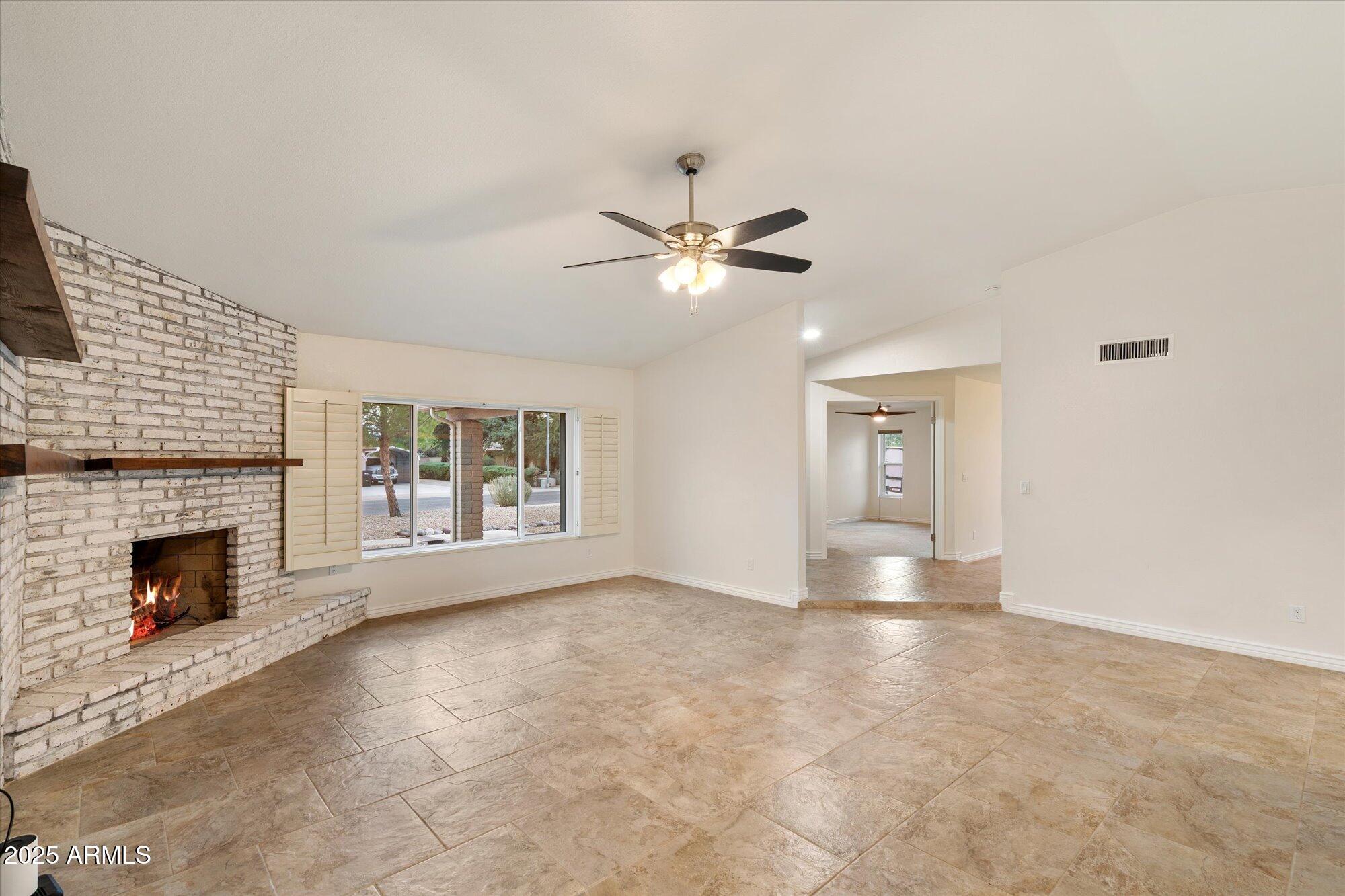 6242 East Hearn Road Scottsdale, AZ 85254 - Photo 7 of 40 an empty room with windows and fireplace