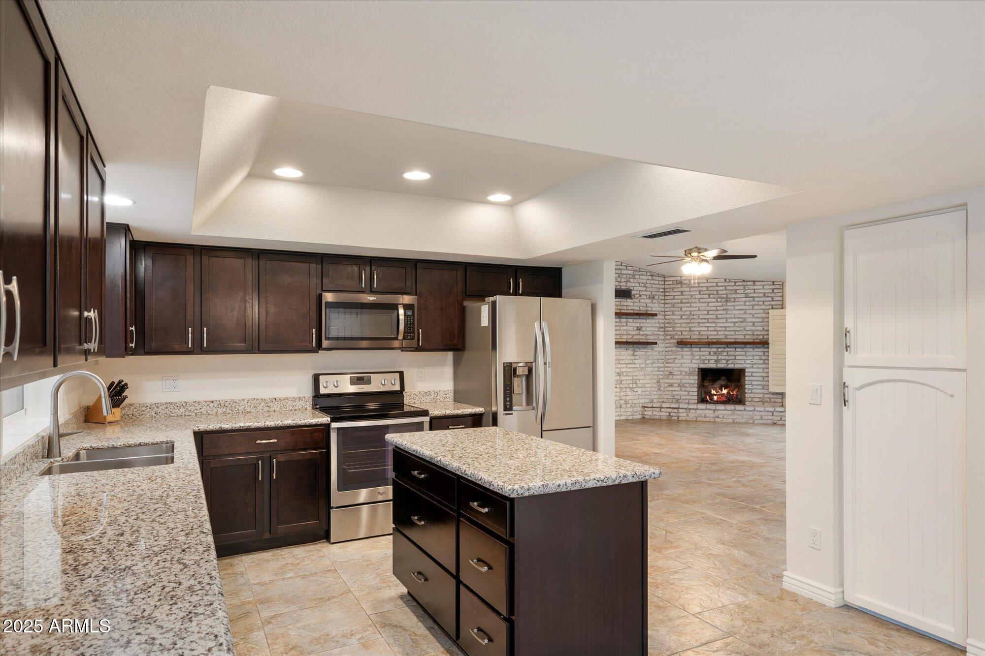 6242 East Hearn Road Scottsdale, AZ 85254 - Photo 40 of 40 a kitchen with stainless steel appliances granite countertop a refrigerator a sink a stove a microwave and island