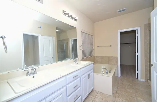 a bathroom with a bathtub and a shower