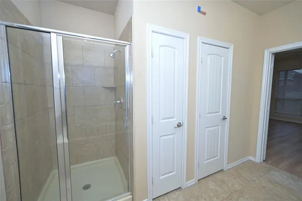 a bathroom with a tub sink shower and mirror